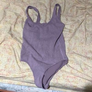 Purple woman’s body suit